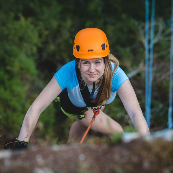 Climbing-teen-girl-close-up-smile-challenge-landscape.jpeg