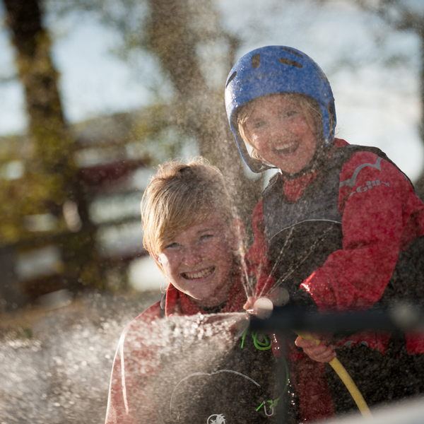 Children holding Water Hose.png